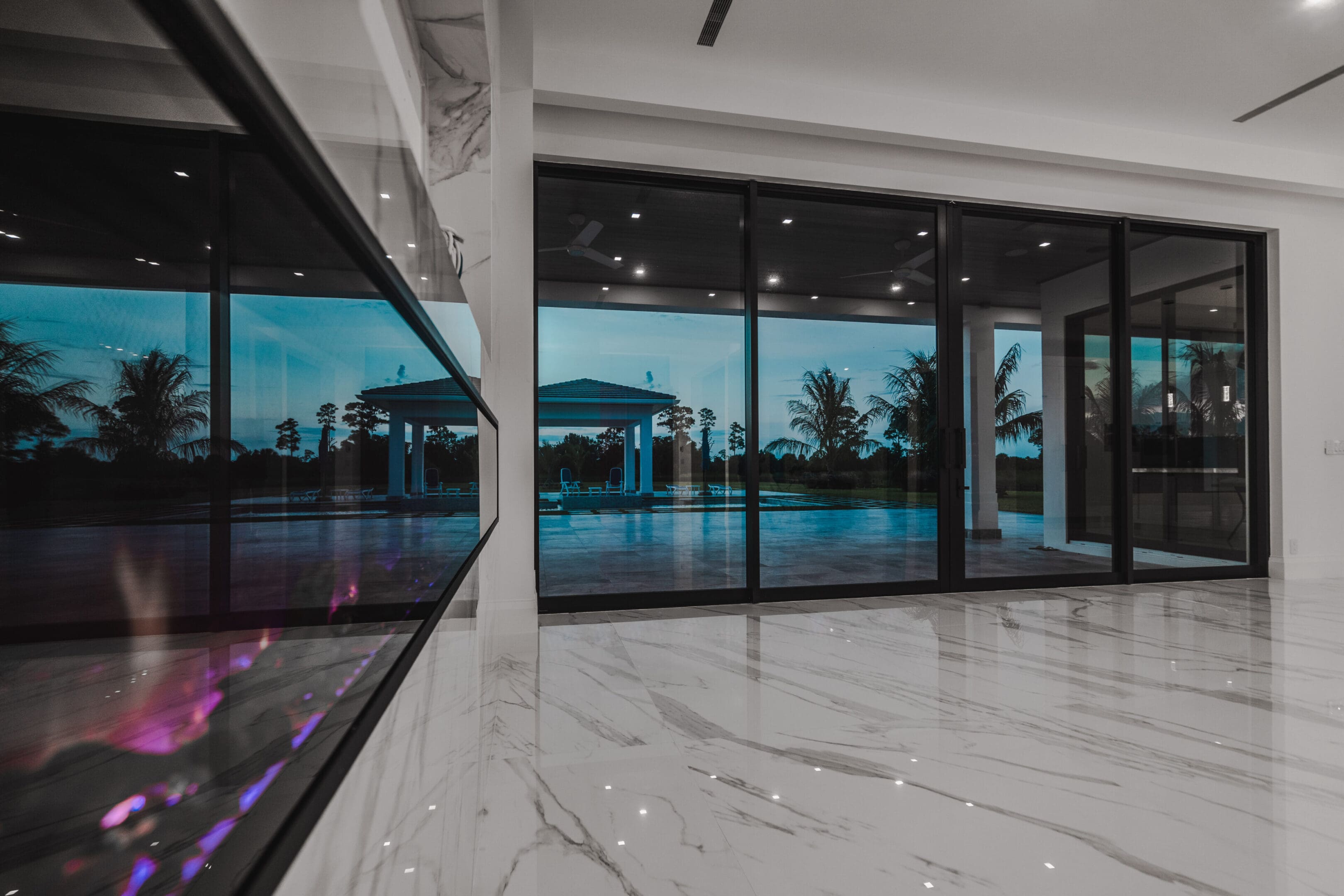 A large room with glass walls and marble floors.