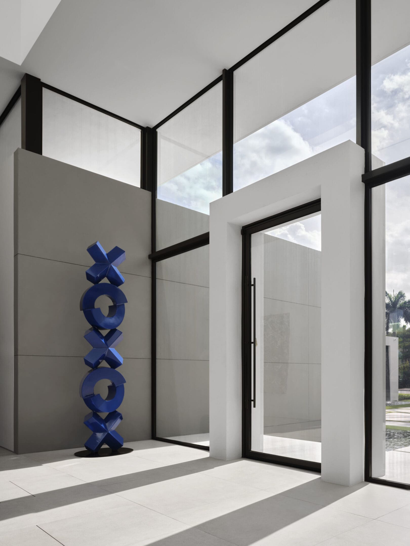 A blue sculpture in front of a window.